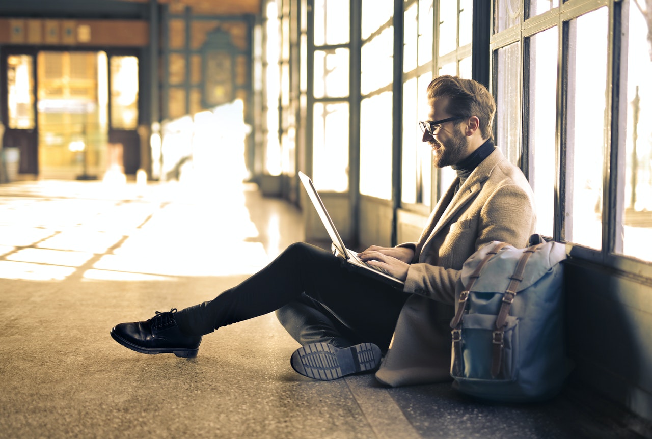 man in airport on laptop