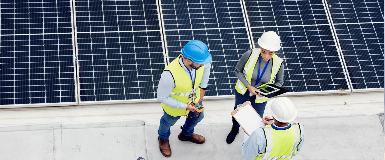 Engineering solar panel and top view of team in discussion for inspection or installation
