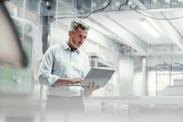man with the laptop in the factory
