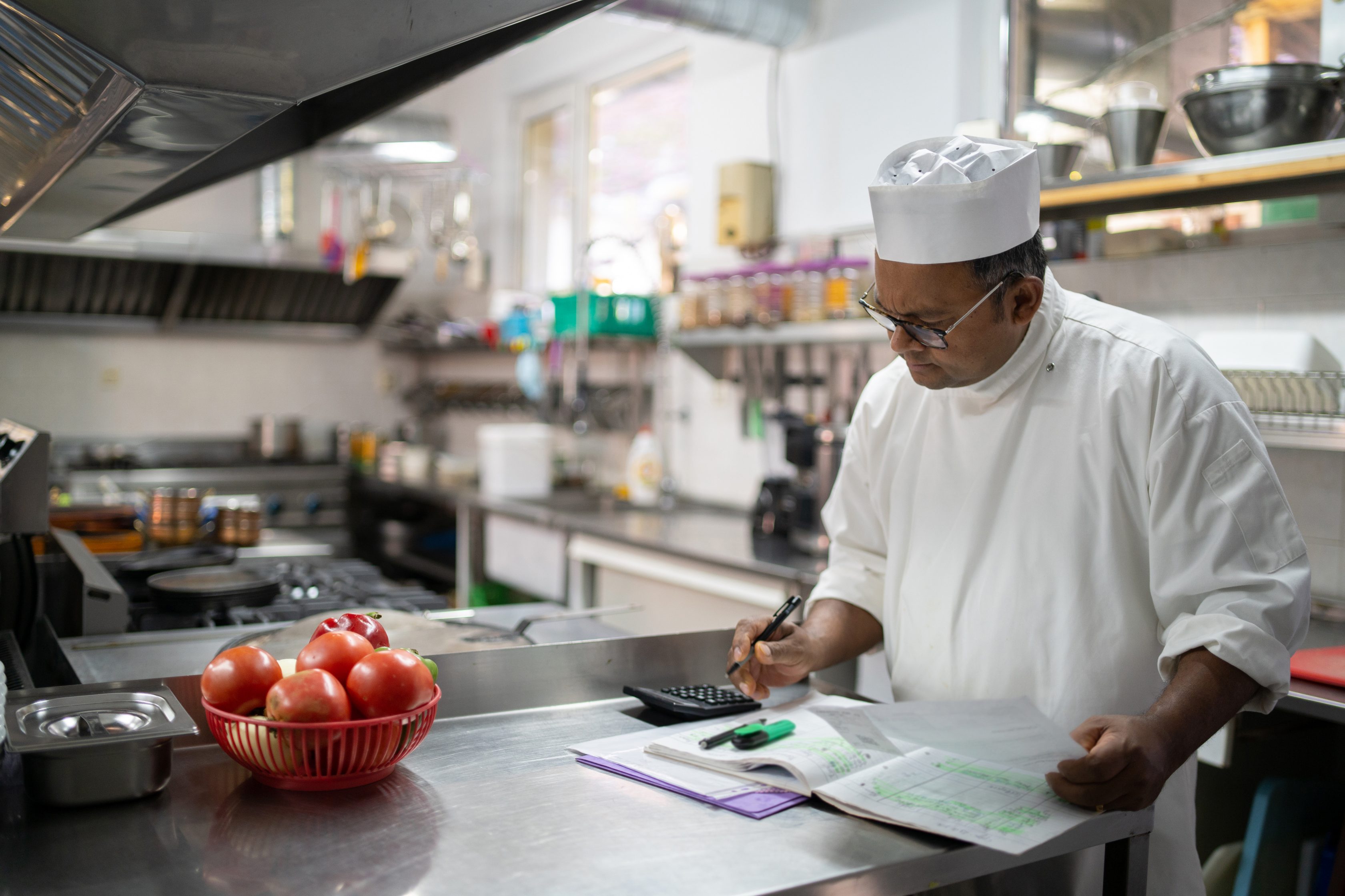 chef in kitchen looking at menu