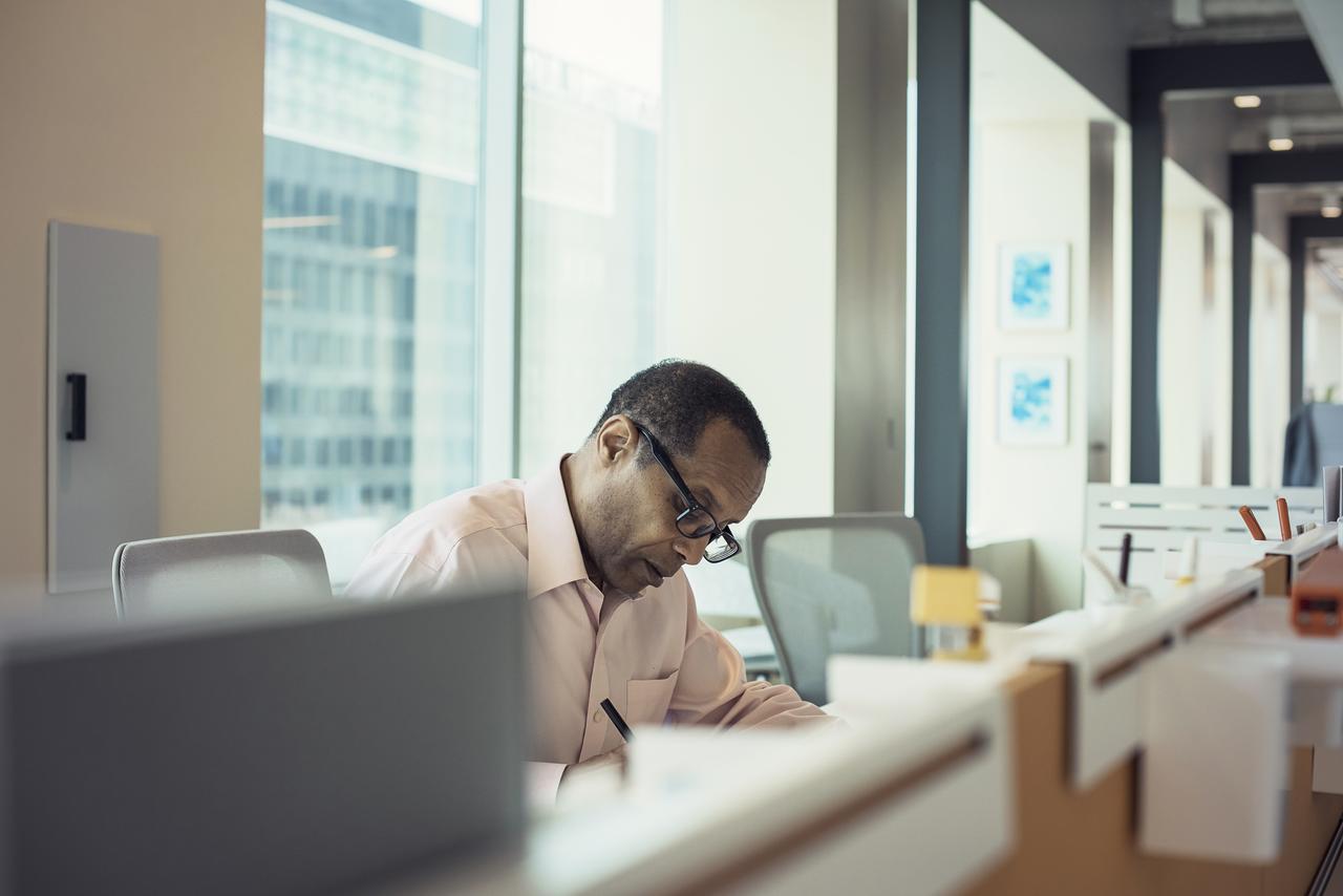 office setting with man looking down at report