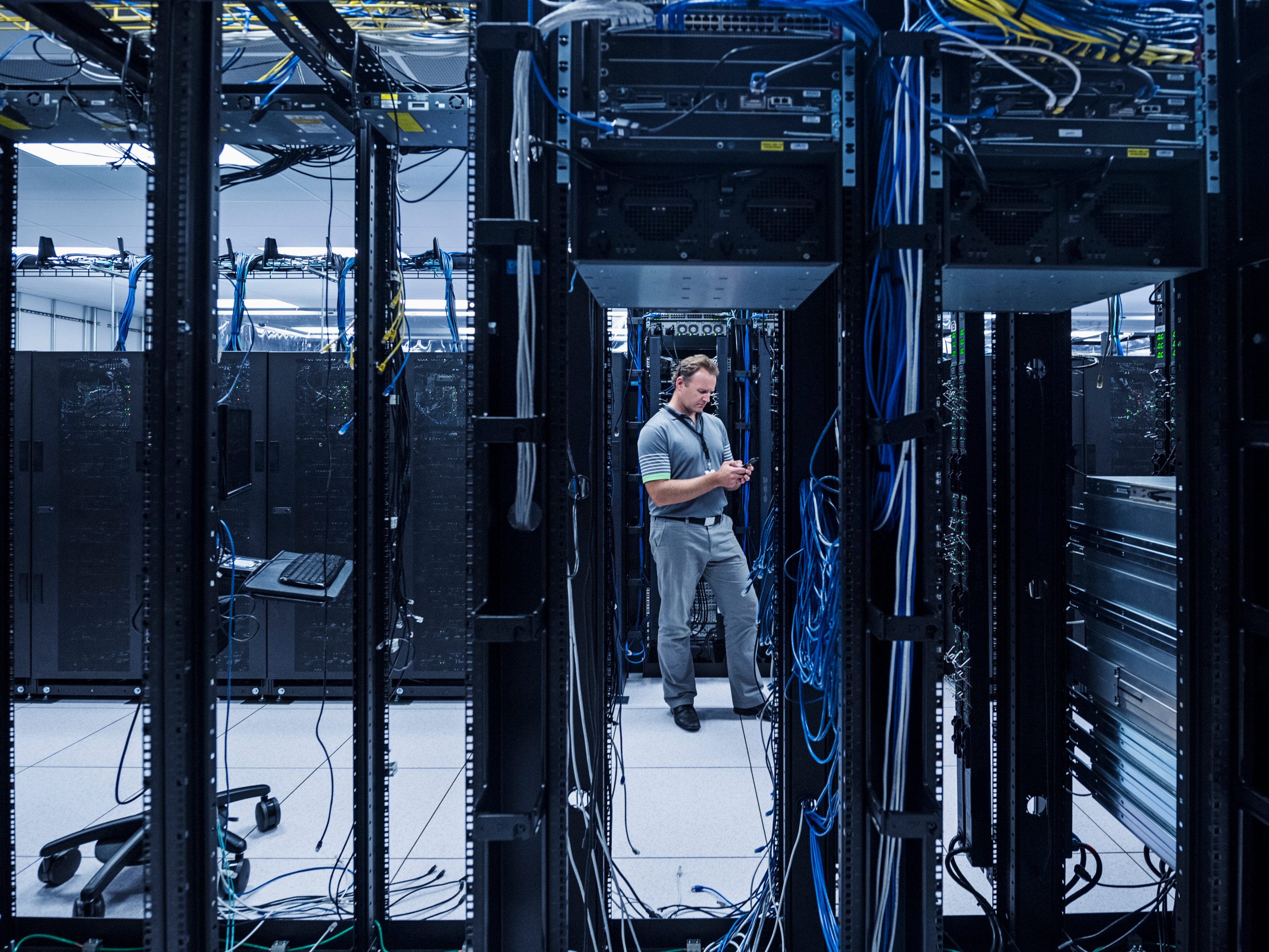 man standing inside of a network room