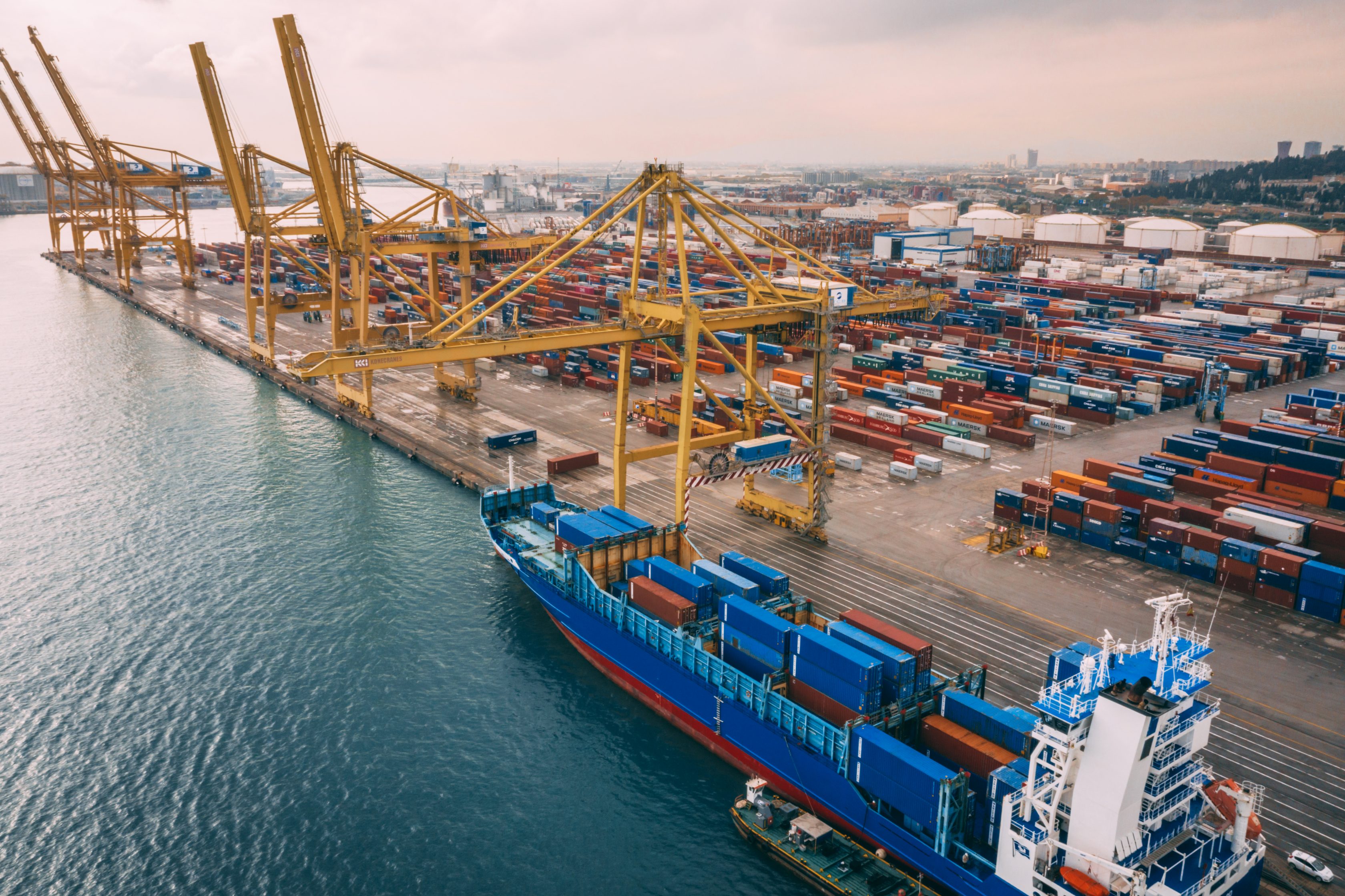 cargo shipped docked at a port with cranes