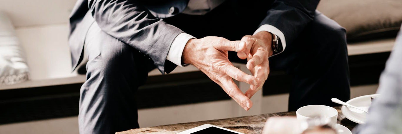 man in suit with hands out