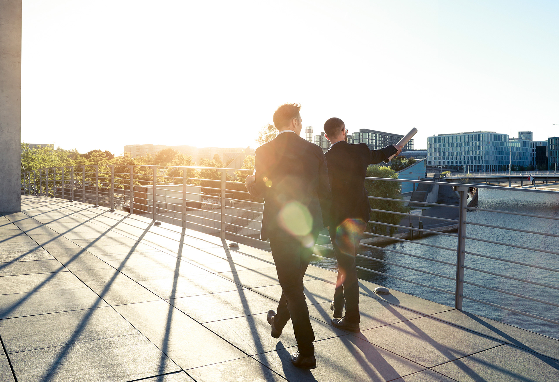 two men walking on bridge