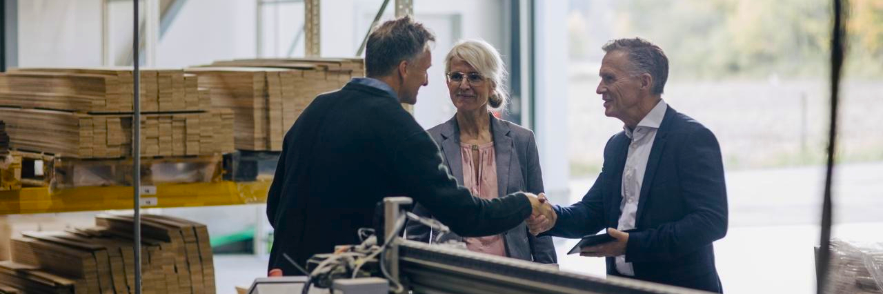 three people shaking hands together